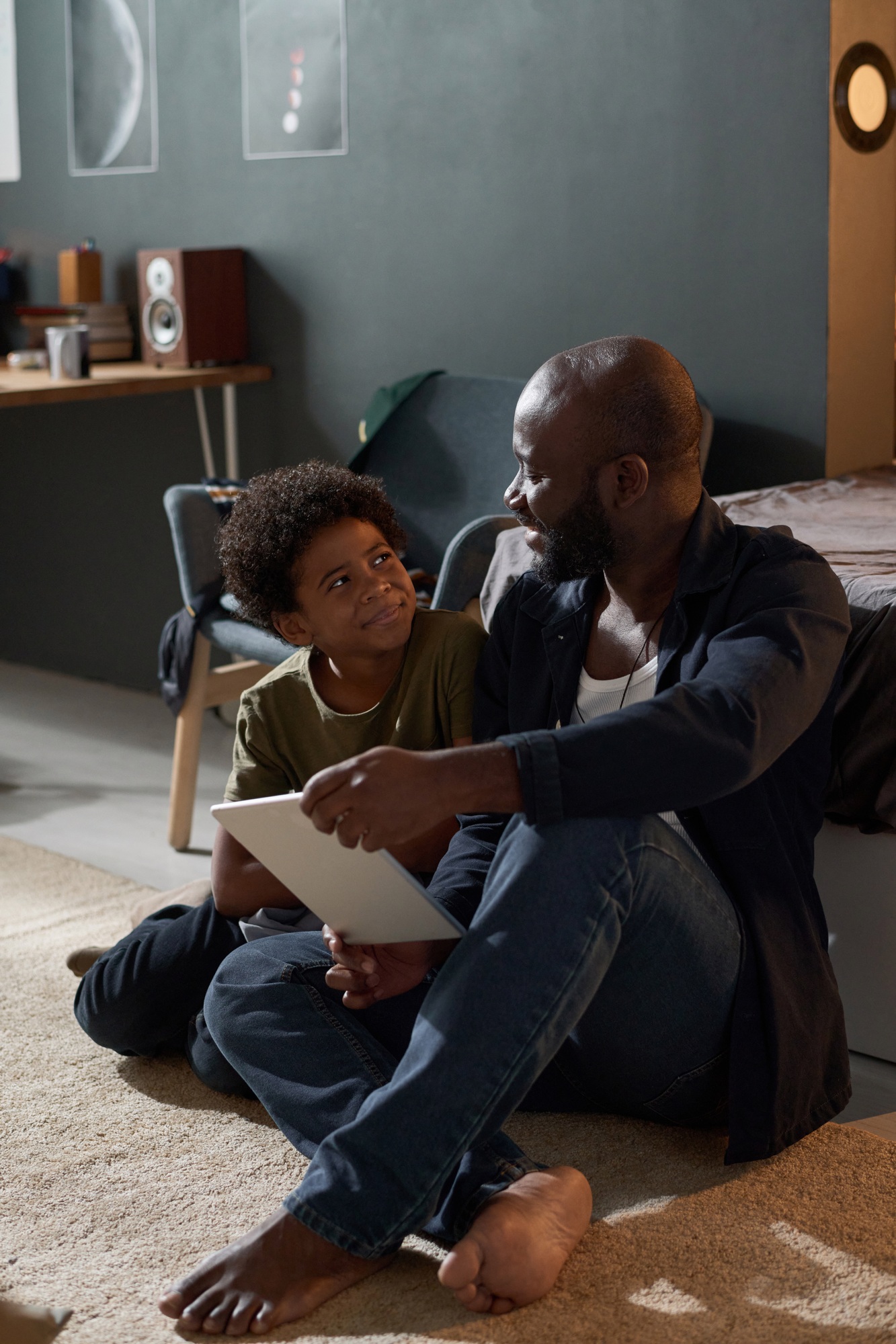 Black Family Of Dad and Son Using Tablet