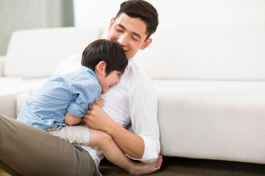 Father and son in living room