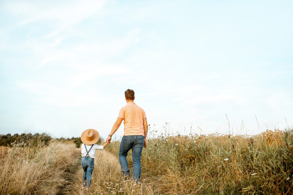 Father and son walking in the field